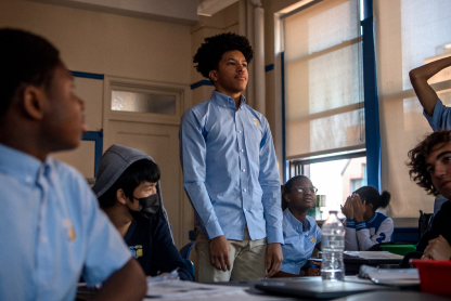 A student standing up in a classroom